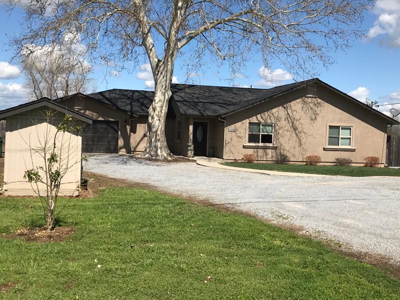 a view of house with yard