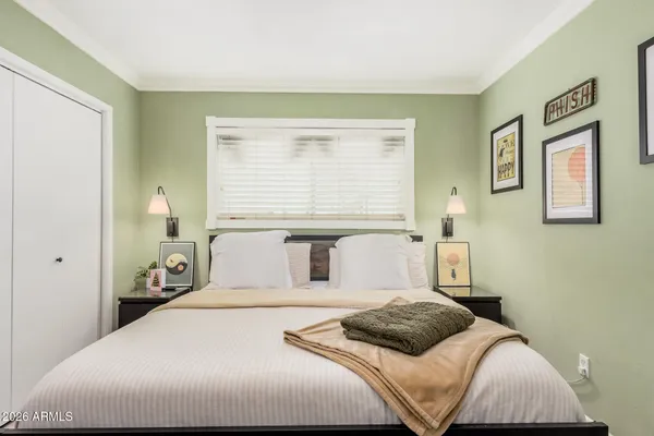 a bedroom with a large bed and a window