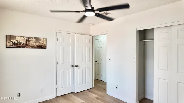 a view of a small space with wooden floor and a window