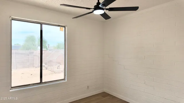 a view of a hallway with wooden floor and closet