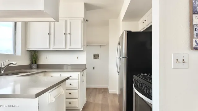 a kitchen with stainless steel appliances granite countertop a refrigerator and a sink