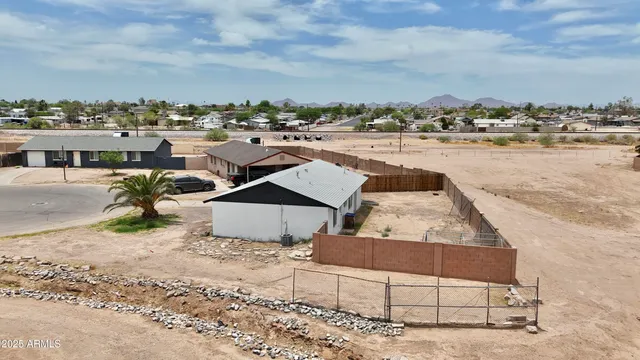 a front view of a house with a tree in front