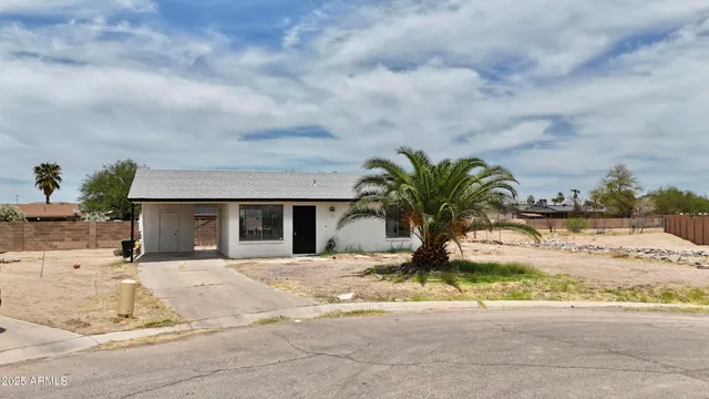 a view of a house with snow on the road