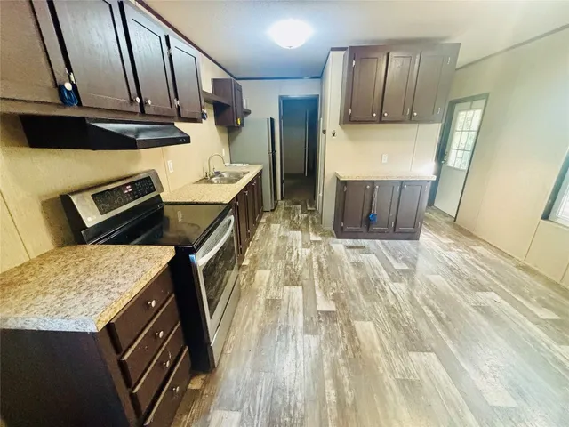 a kitchen with a sink stove and refrigerator