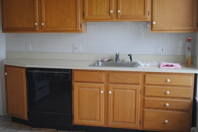 a kitchen with cabinets and appliances