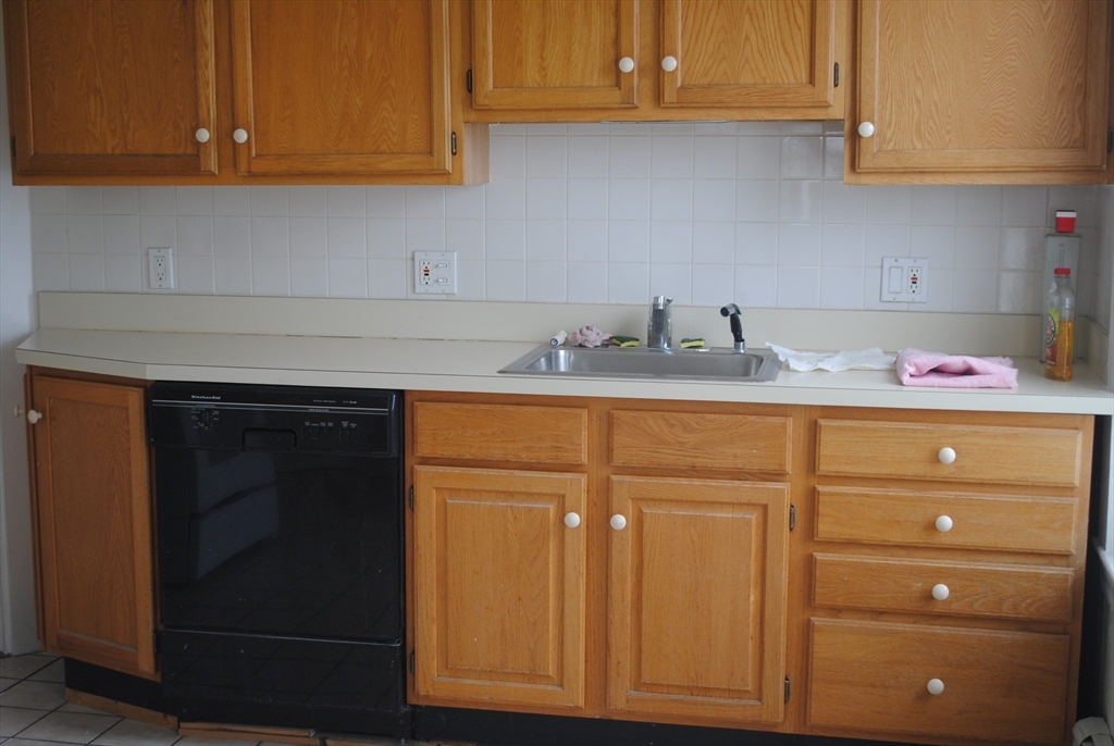 a kitchen with cabinets and appliances
