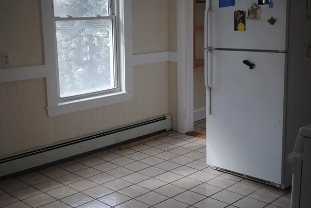 a view of a room with wooden floor and window