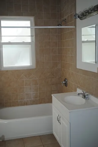 a bathroom with a sink a bathtub and a shower