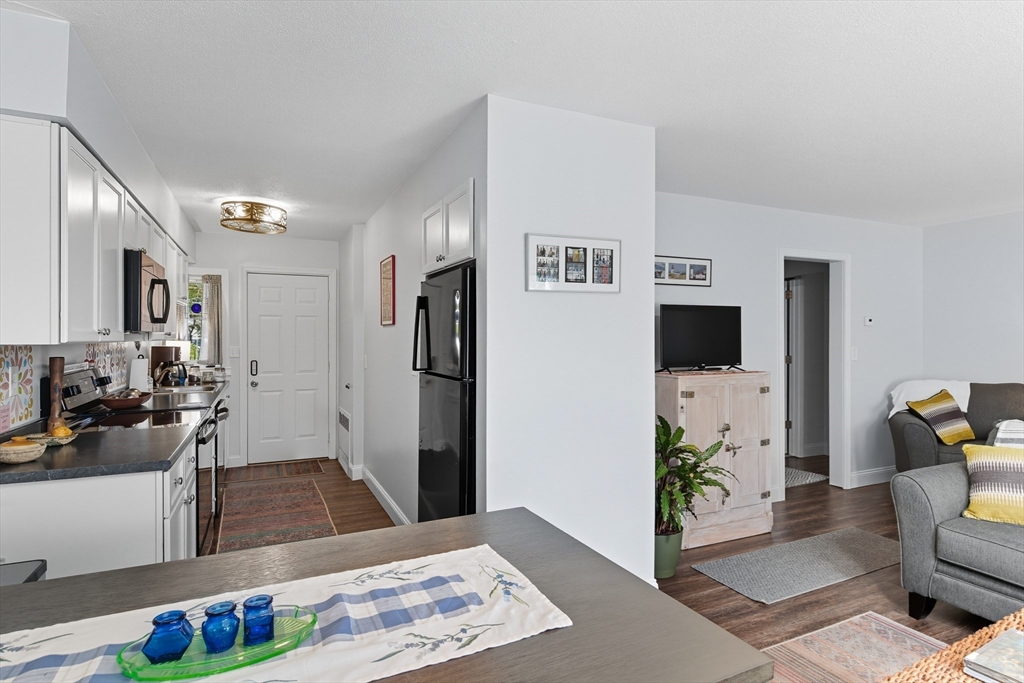 45 Doverbrook Road, Unit 45 Chicopee, MA 01022 - Photo 11 of 33 a living room with furniture and a flat screen tv