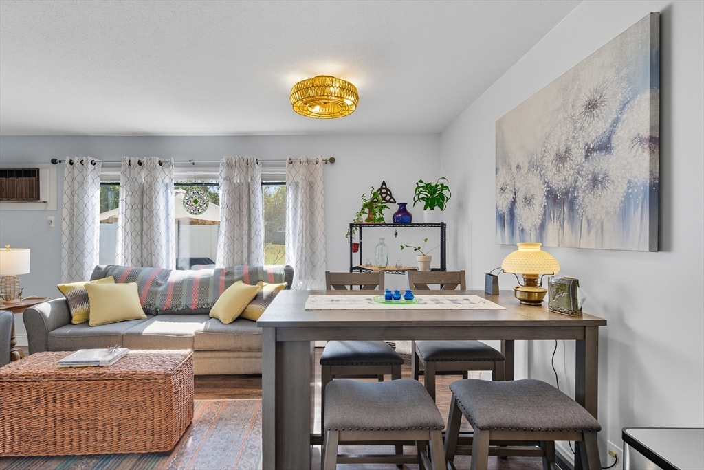 45 Doverbrook Road, Unit 45 Chicopee, MA 01022 - Photo 15 of 33 a dining room with furniture and wooden floor