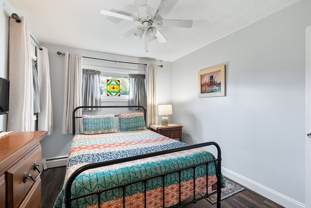 45 Doverbrook Road, Unit 45 Chicopee, MA 01022 - Photo 21 of 33 a bedroom with a bed and a chandelier