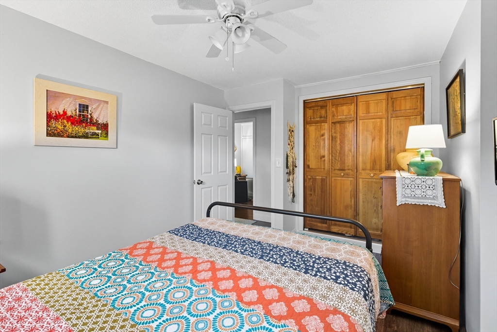 45 Doverbrook Road, Unit 45 Chicopee, MA 01022 - Photo 22 of 33 a bedroom with a bed and a chandelier