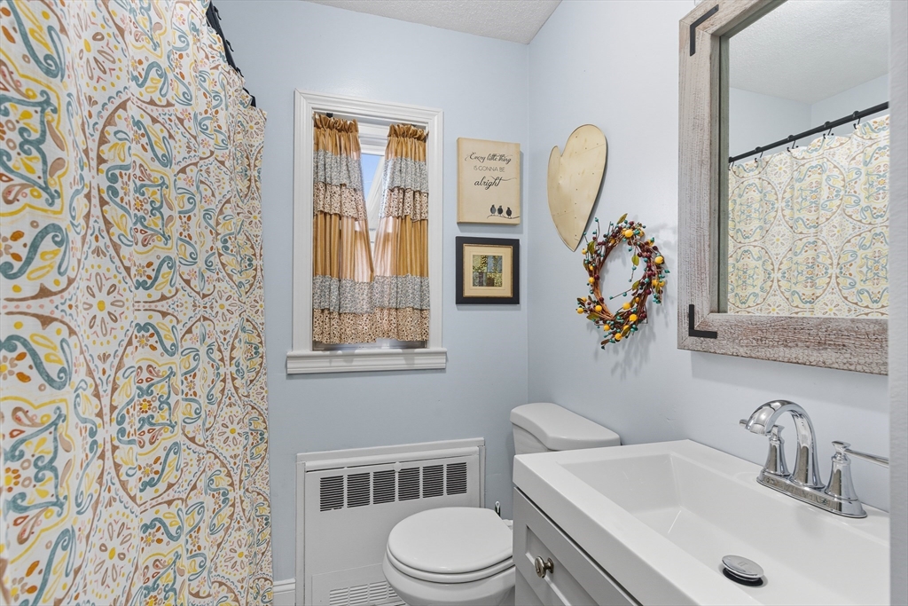 45 Doverbrook Road, Unit 45 Chicopee, MA 01022 - Photo 25 of 33 a bathroom with a toilet sink and mirror