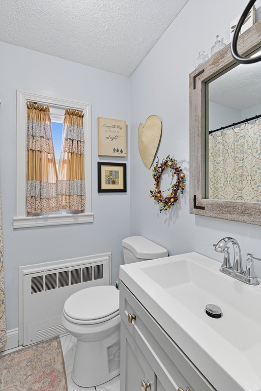 45 Doverbrook Road, Unit 45 Chicopee, MA 01022 - Photo 26 of 33 a bathroom with a sink a toilet and a mirror