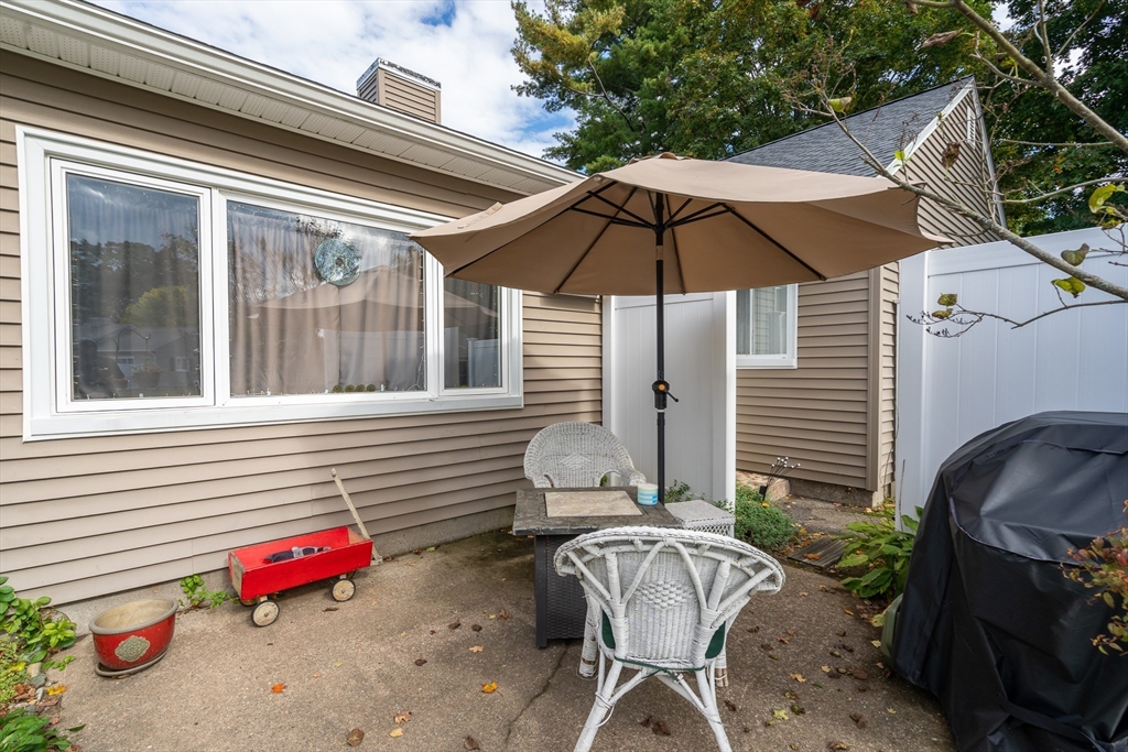 45 Doverbrook Road, Unit 45 Chicopee, MA 01022 - Photo 30 of 33 an outdoor space with furniture and umbrella