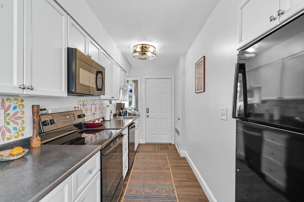 45 Doverbrook Road, Unit 45 Chicopee, MA 01022 - Photo 7 of 33 a kitchen with stainless steel appliances granite countertop a refrigerator a stove and a sink