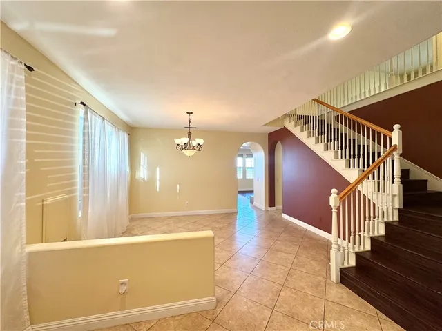 a view of a livingroom with wooden floor and stairs