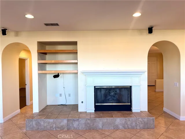 a view of an empty room and a fireplace