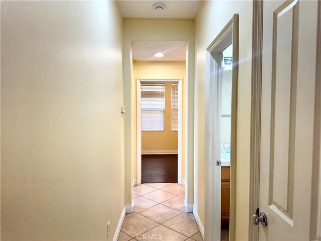a view of a hallway with wooden shelves