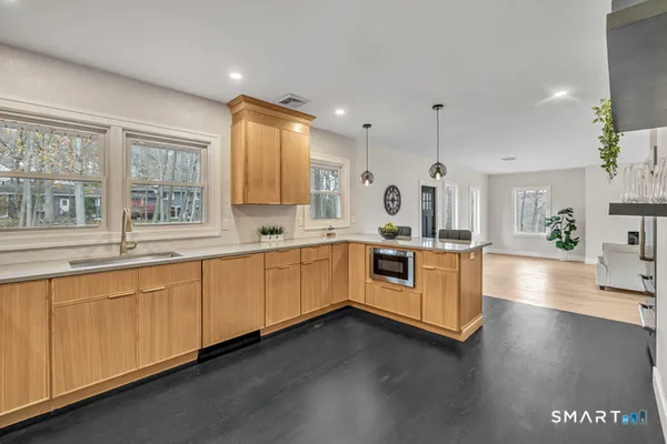 a large white kitchen with a large window