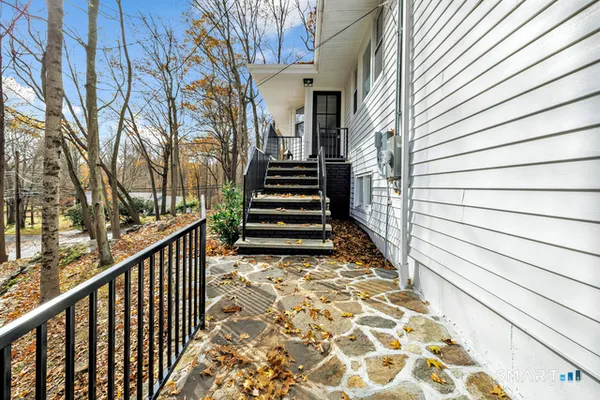 a view of a balcony with wooden floor and fence