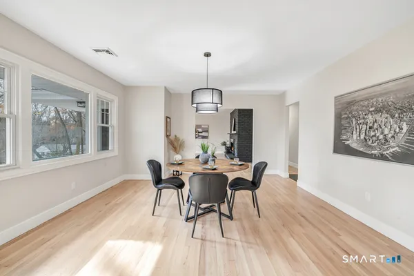 a view of a dining room with furniture window and wooden floor