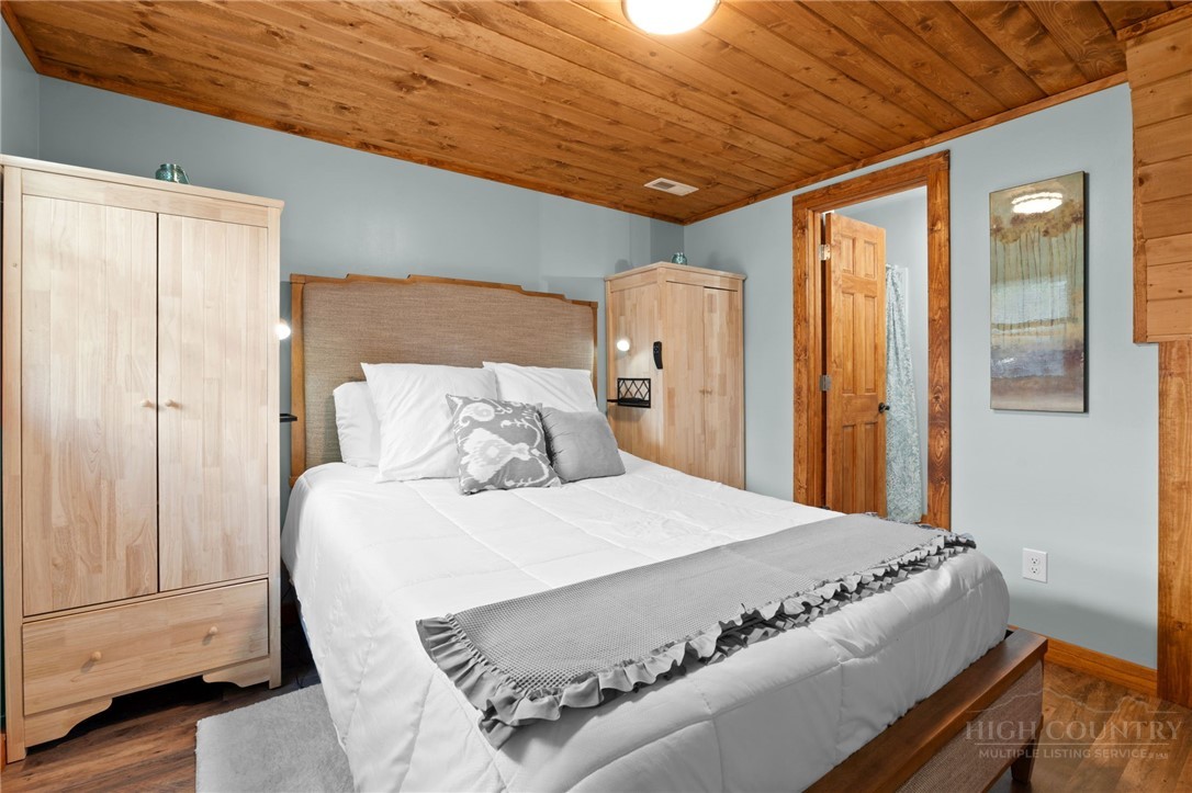 139 Golden Rod Loop Newland, NC 28657 - Photo 22 of 39 a bed sitting in a bedroom next to a bathroom