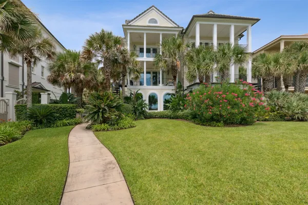 a front view of a house with a garden