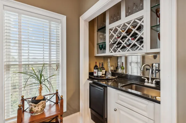 a bathroom with a granite countertop sink toilet a mirror and shower