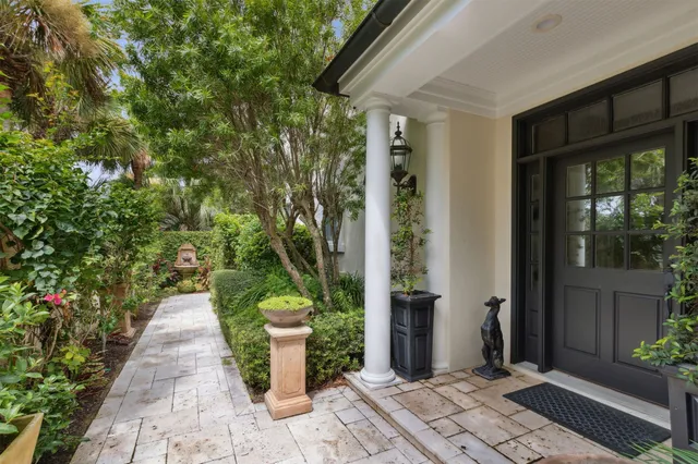a path view of a house with a backyard