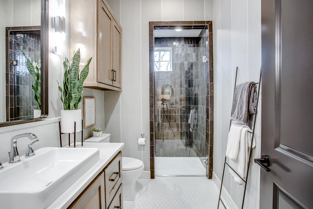 4821 119th Place Lubbock, TX 79424 - Photo 34 of 77 a bathroom with a granite countertop shower a sink and a mirror