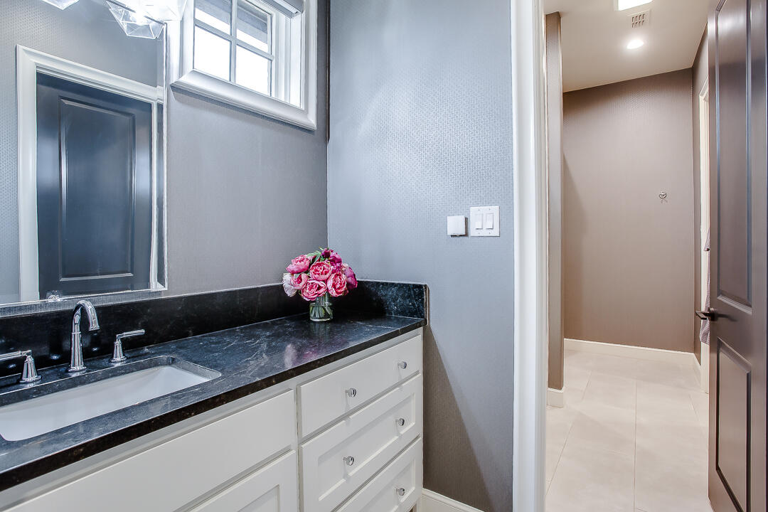 4821 119th Place Lubbock, TX 79424 - Photo 38 of 77 a bathroom with a granite countertop sink and a mirror