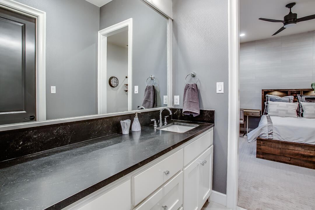 4821 119th Place Lubbock, TX 79424 - Photo 40 of 77 a en suite bathroom with a sink and a mirror