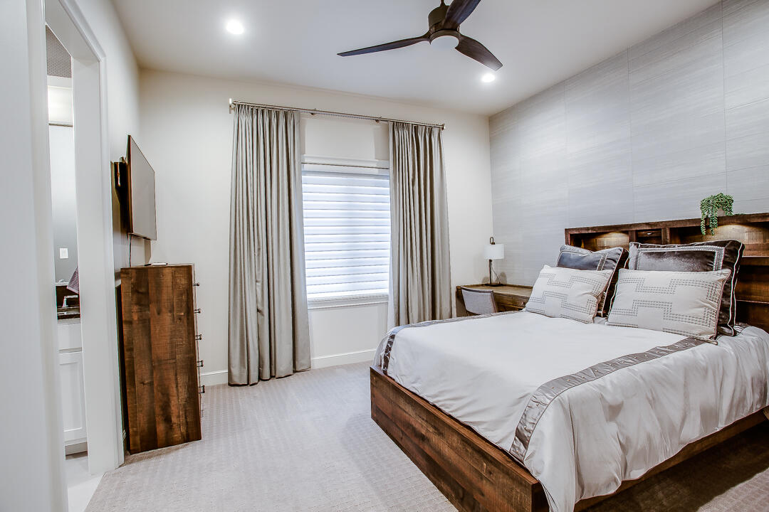 4821 119th Place Lubbock, TX 79424 - Photo 41 of 77 a bedroom with a bed closet and flat screen tv