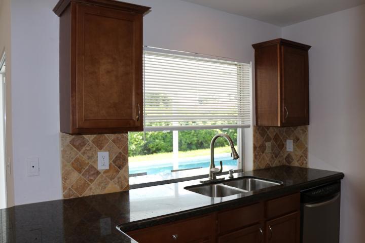 9 Burning Tree Lane Boca Raton, FL 33431 - Photo 11 of 26 a kitchen with a sink a counter top space and a window