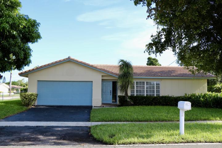 9 Burning Tree Lane Boca Raton, FL 33431 - Photo 2 of 26 a front view of a house with a yard