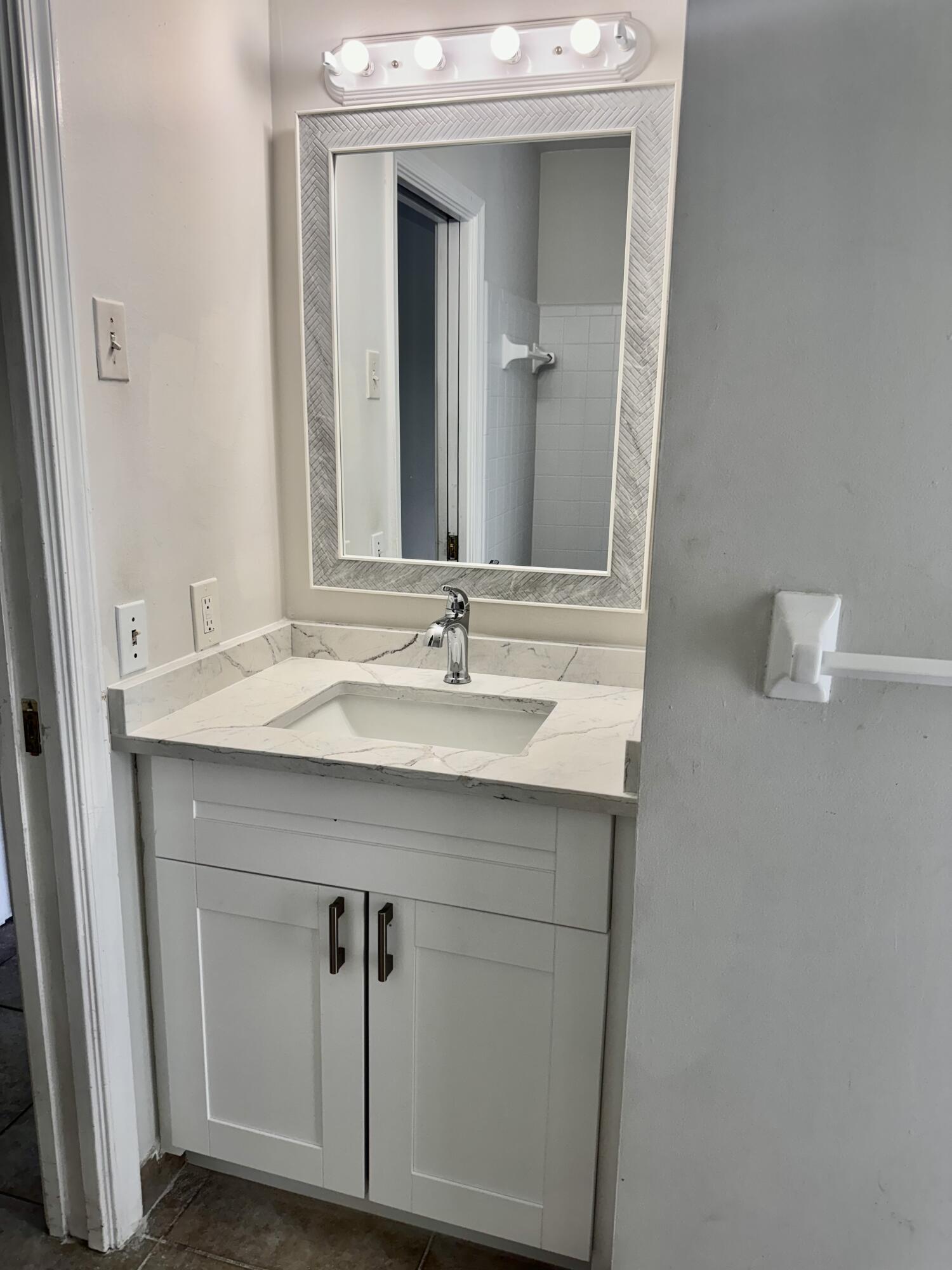 9 Burning Tree Lane Boca Raton, FL 33431 - Photo 25 of 26 a bathroom with a sink vanity and a mirror