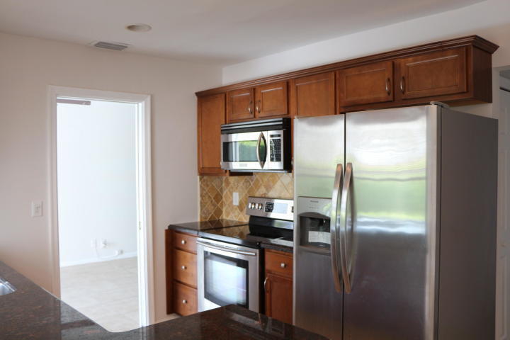 9 Burning Tree Lane Boca Raton, FL 33431 - Photo 10 of 26 a kitchen with stainless steel appliances granite countertop a refrigerator and a sink