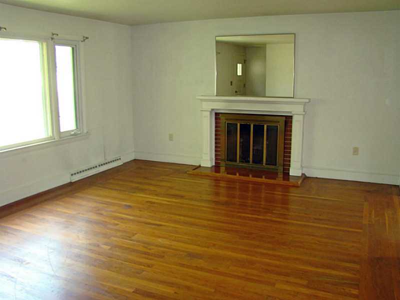121 Ruggles Avenue Newport, RI 02840 - Photo 5 of 25 Living Room. Hardwood floors and wood burning fireplace.