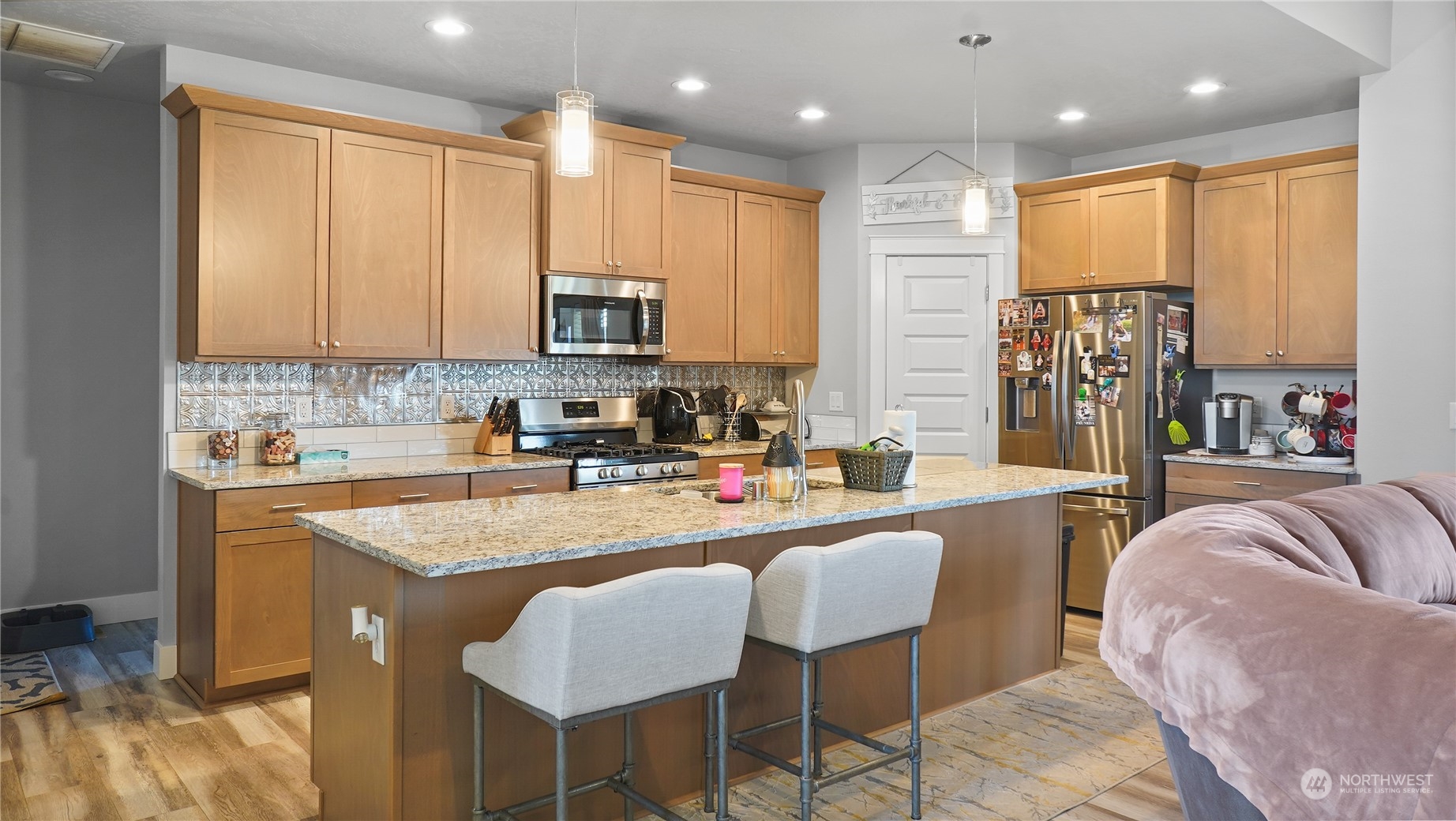 1300 E Mount Othello, WA 99344 - Photo 3 of 36 a large kitchen with kitchen island granite countertop a stove a sink a dining table and chairs