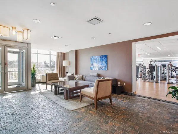 a living room with furniture and a floor to ceiling window