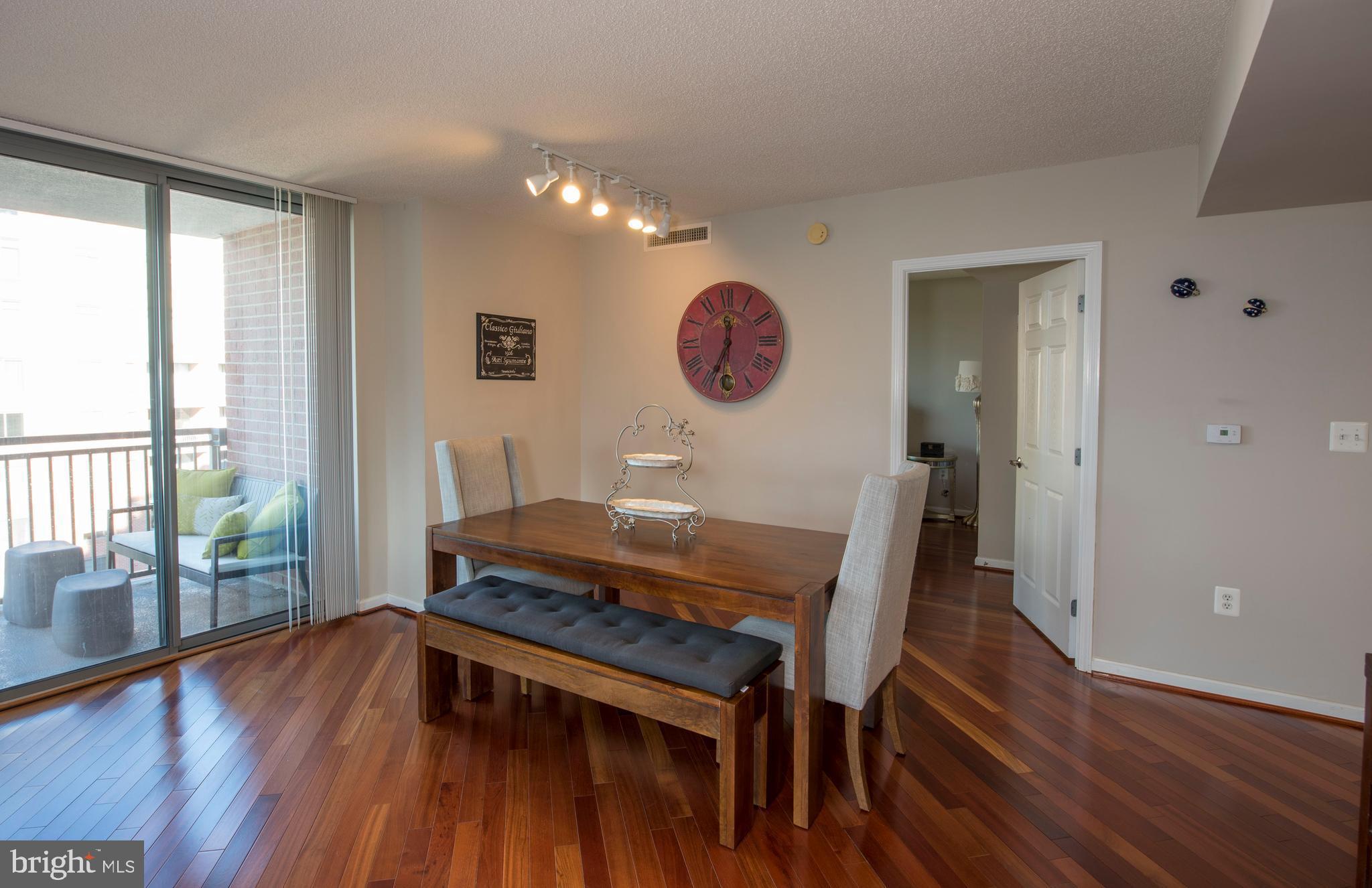11710 Old Georgetown Road, Unit 1330 North Bethesda, MD 20852 - Photo 14 of 29 a view of a dining room with furniture and wooden floor