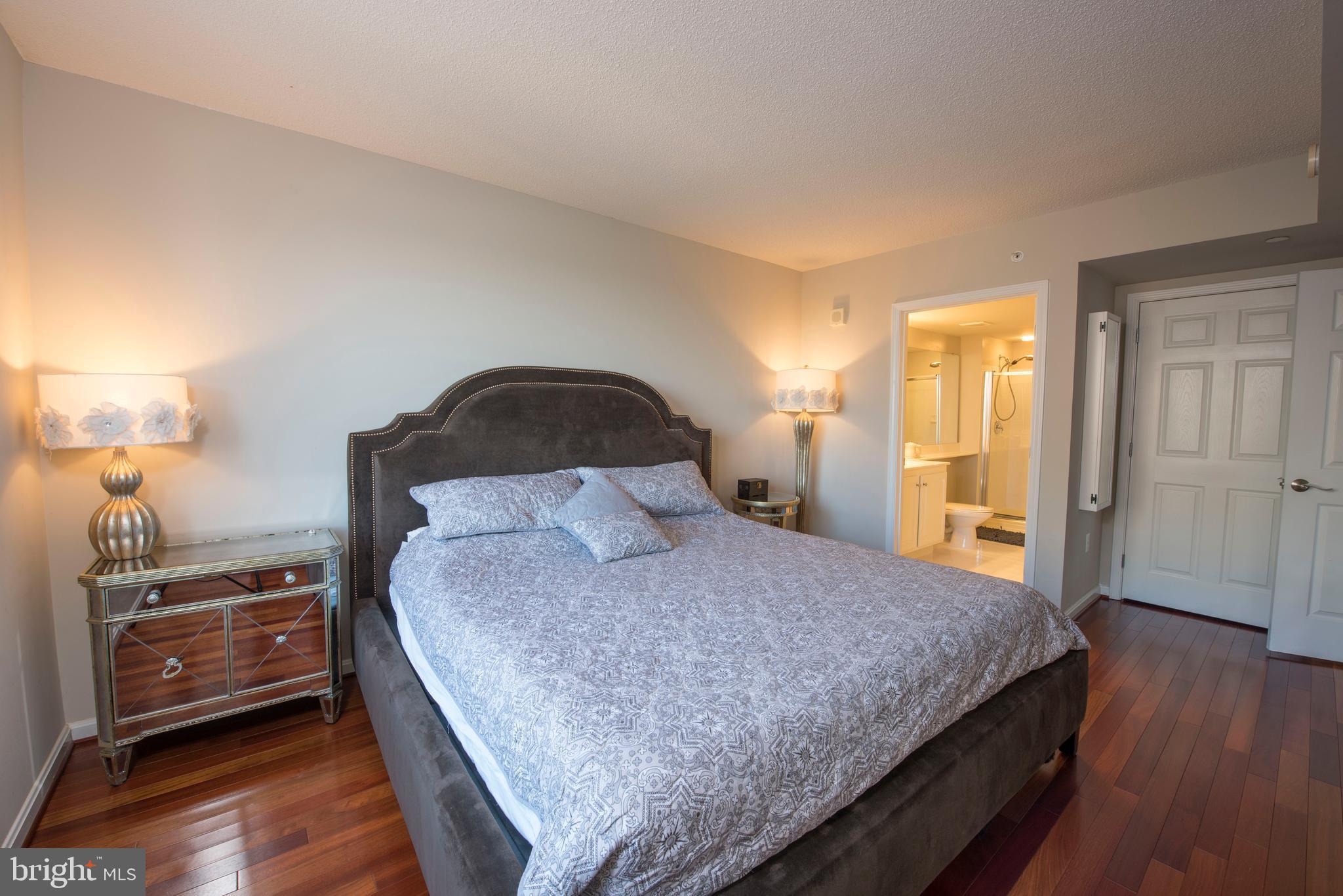 11710 Old Georgetown Road, Unit 1330 North Bethesda, MD 20852 - Photo 15 of 29 a bedroom with a bed and wooden floor