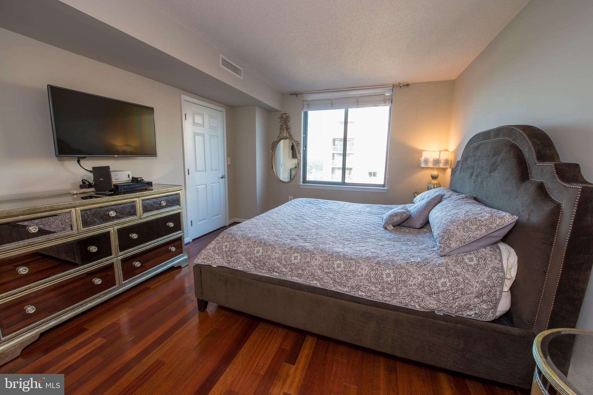 11710 Old Georgetown Road, Unit 1330 North Bethesda, MD 20852 - Photo 17 of 29 a bedroom with a bed and a flat screen tv
