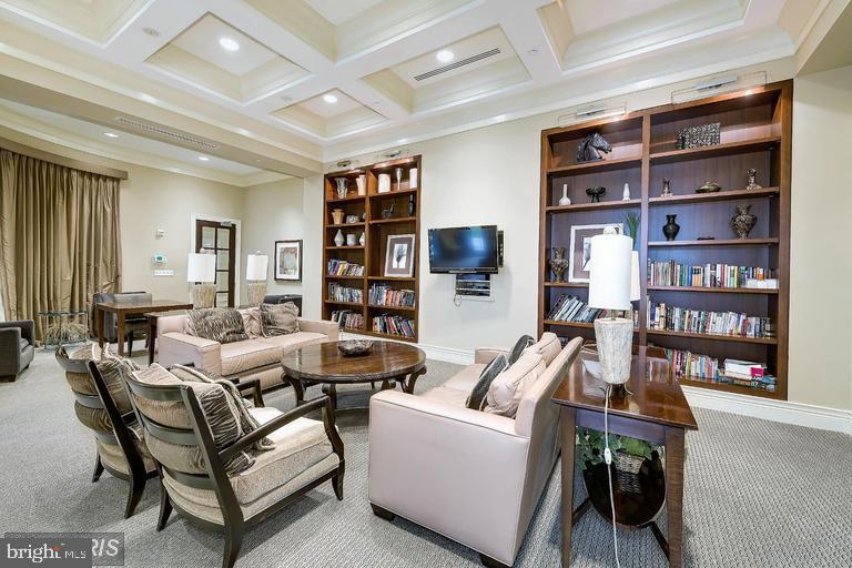 11710 Old Georgetown Road, Unit 1330 North Bethesda, MD 20852 - Photo 27 of 29 a living room with lots of furniture and a book shelf