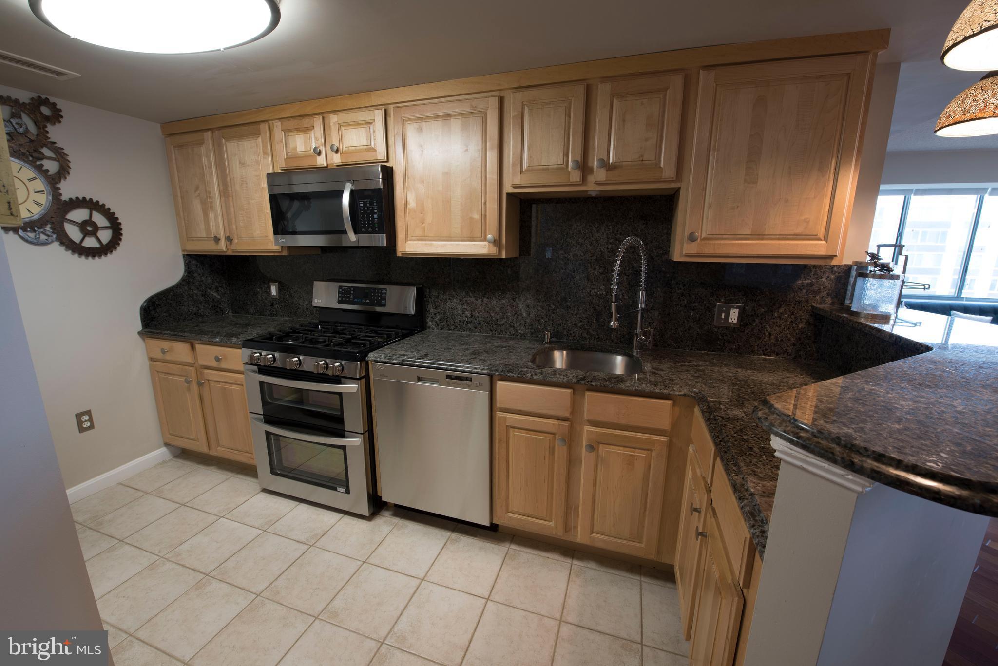 11710 Old Georgetown Road, Unit 1330 North Bethesda, MD 20852 - Photo 4 of 29 a kitchen with granite countertop white cabinets and stainless steel appliances
