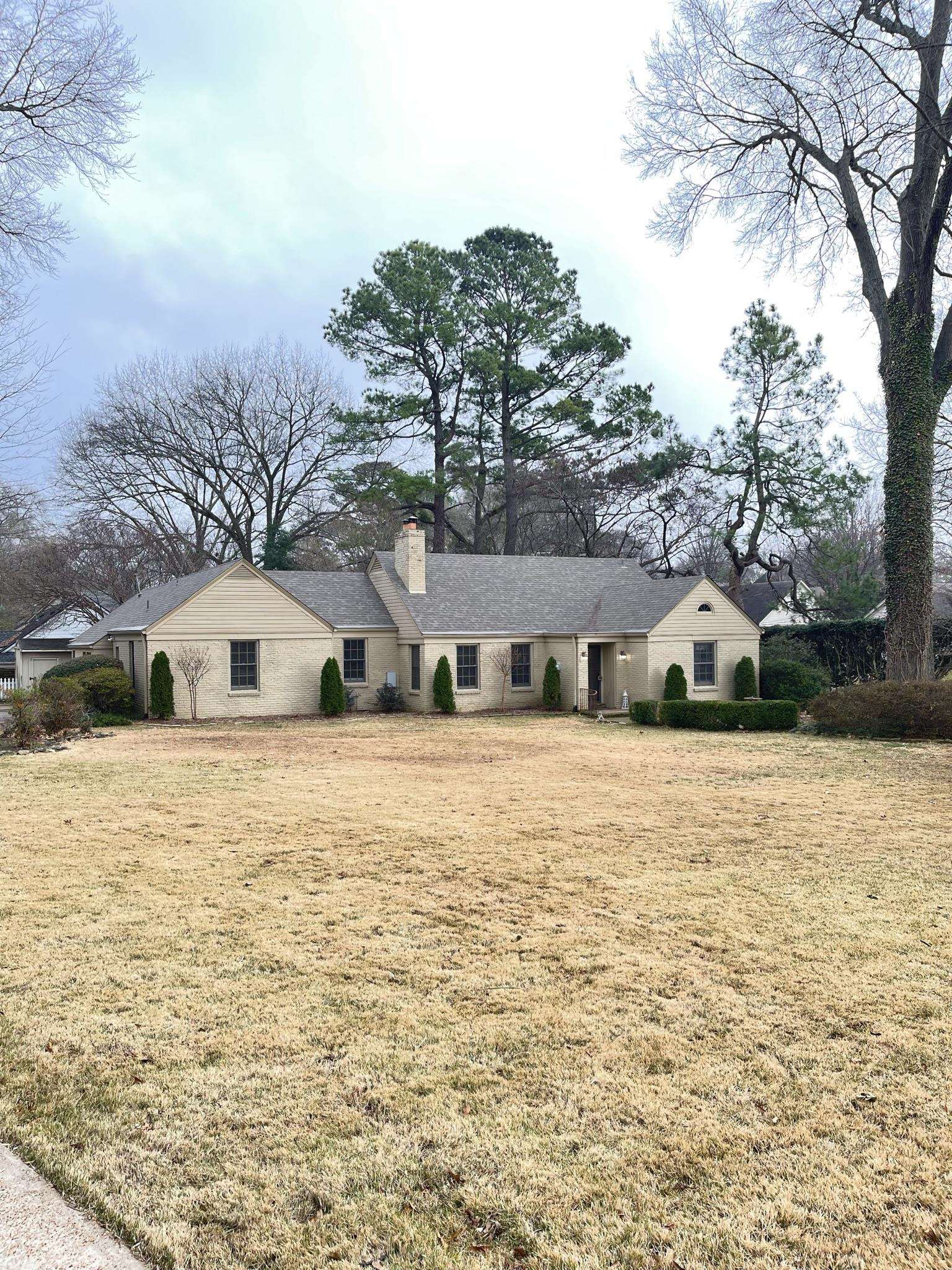 434 Colonial Road Memphis, TN 38117 - Photo 2 of 23 a front view of a house with a yard and mountain view in back