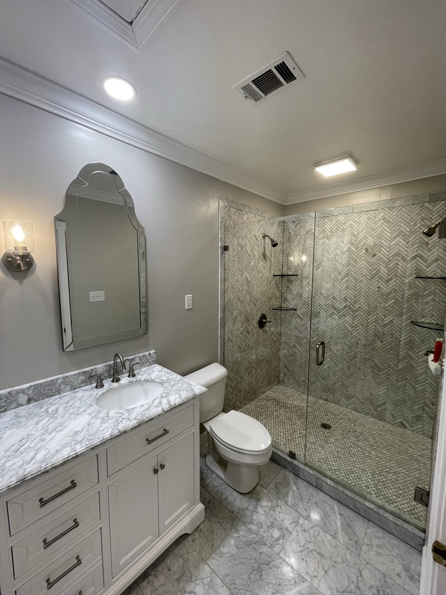 434 Colonial Road Memphis, TN 38117 - Photo 22 of 23 a bathroom with a double vanity sink toilet and shower