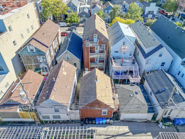 a aerial view of a brick building next to a yard