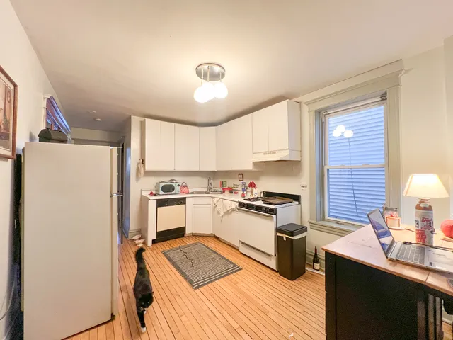 a kitchen with a stove a sink and a refrigerator